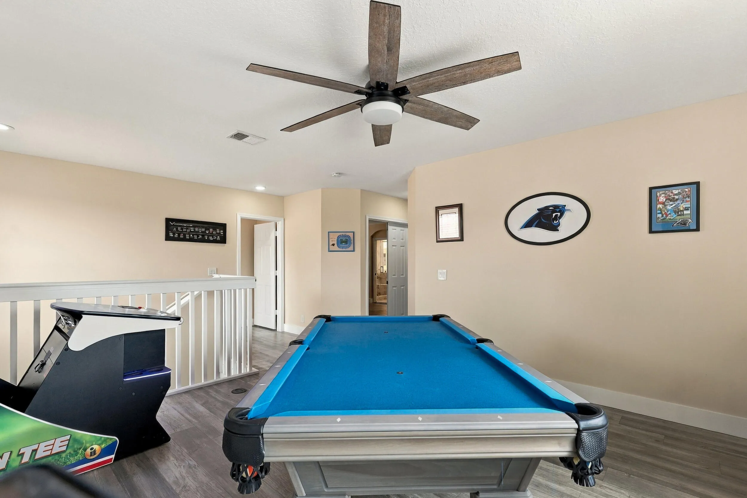 Upstairs is an entertainer's dream. The loft space (which could be a fifth bedroom) is currently a game room with a pool table, arcade games, and is a great space to relax and unwind. This home is being sold fully furnished!