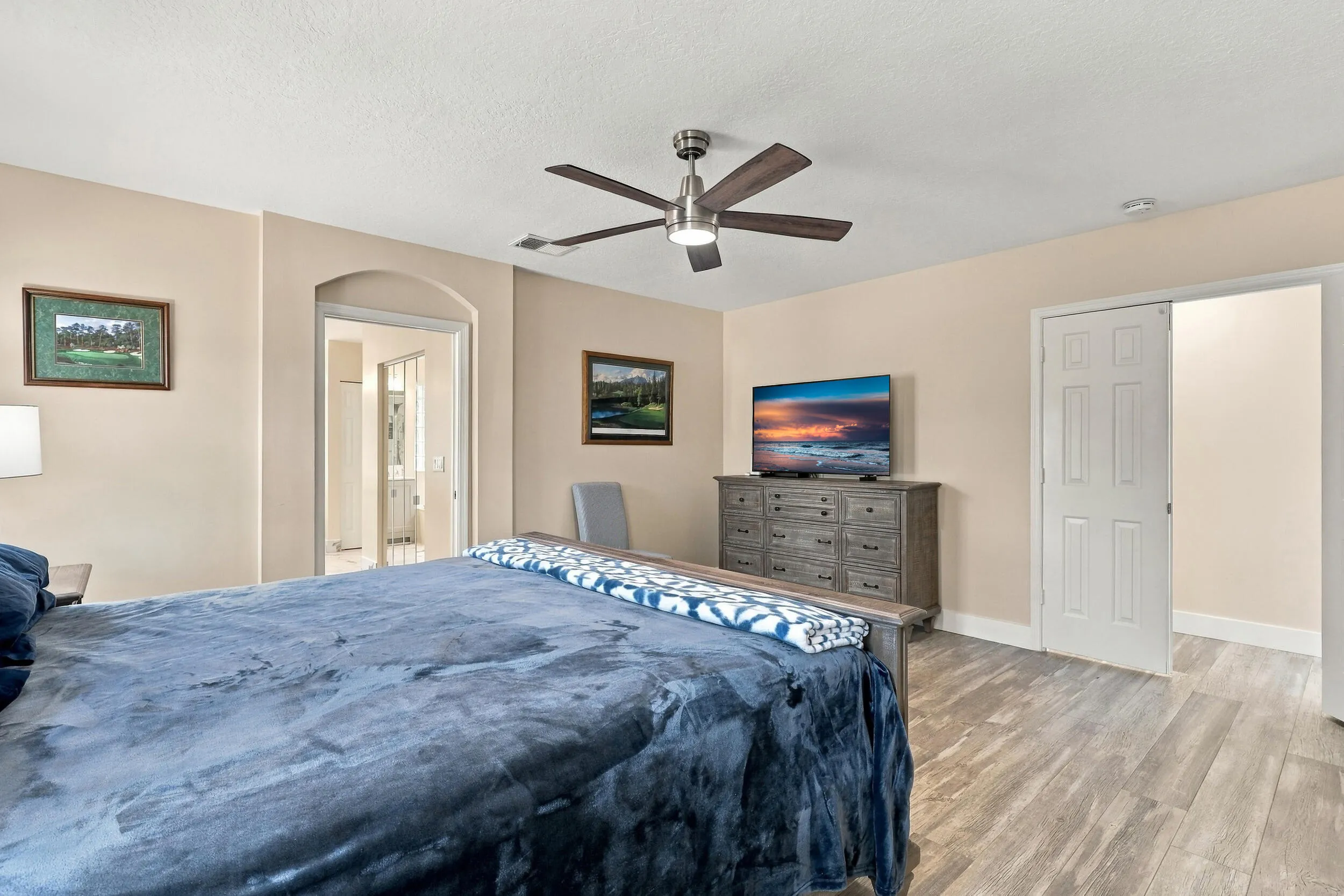 The primary suite is enormous! It offers lots of natural light, a spa-like ensuite bathroom with a marble shower, frameless glass, as well as a walk-in closet and soaking tub.