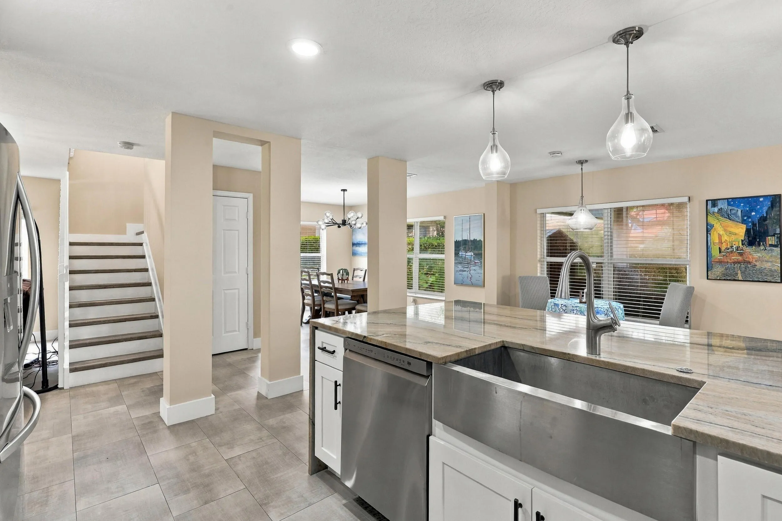 The heart of the home is the exquisite renovated kitchen, featuring white Shaker style cabinetry, stunning quartzite countertops and backsplash, stainless steel appliances, designer lighting, abundant storage, and an oversized island that creates an impressive centerpiece for everyday living and entertaining. The open layout flows effortlessly into the main living areas and breakfast nook, while a separate dining space provides plenty of room for gatherings.