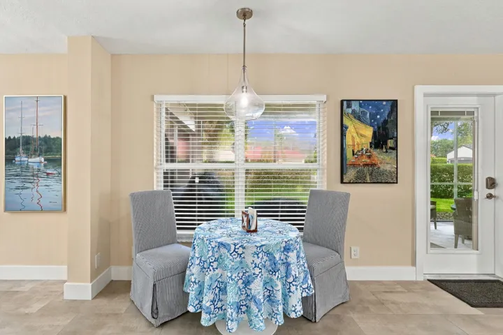 The breakfast nook is a cute, informal space to take in a quick meal underneath a designer light fixture.