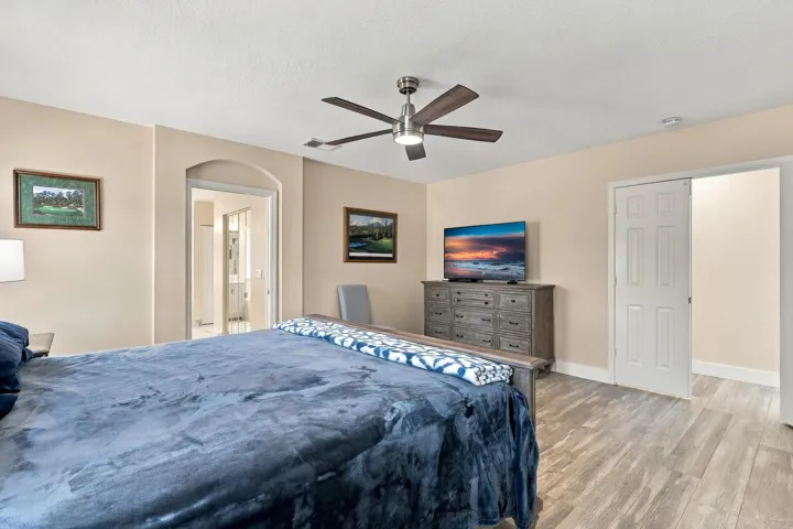 The primary suite is enormous! It offers lots of natural light, a spa-like ensuite bathroom with a marble shower, frameless glass, as well as a walk-in closet and soaking tub.