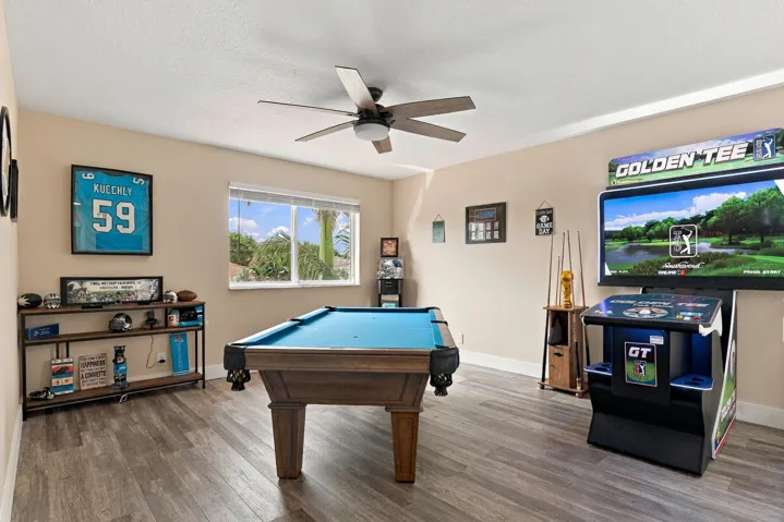 Upstairs is an entertainer's dream. The loft space (which could be a fifth bedroom) is currently a game room with a pool table, arcade games, and is a great space to relax and unwind. This home is being sold fully furnished!