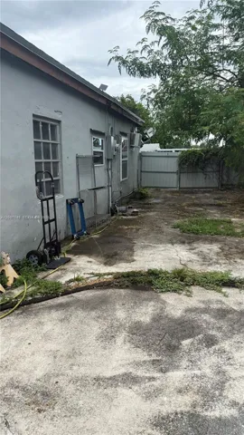 Side of home along fenced yard
