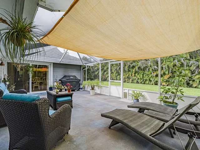 Private Screened patio with a fabric shade structure.