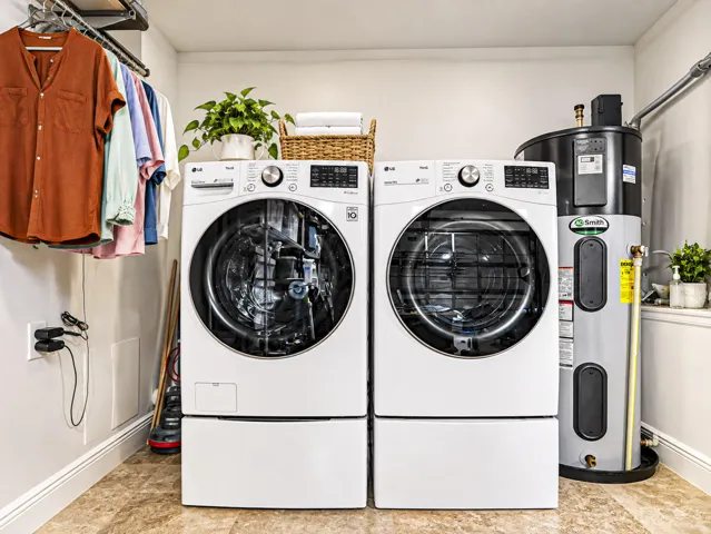 Laundry area in garage with new water heater.