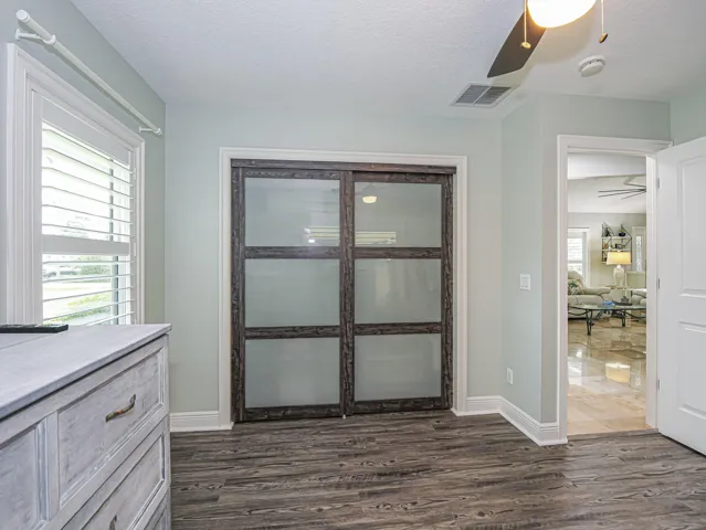 Third Bedroom close with custom frosted glass closet doors.
