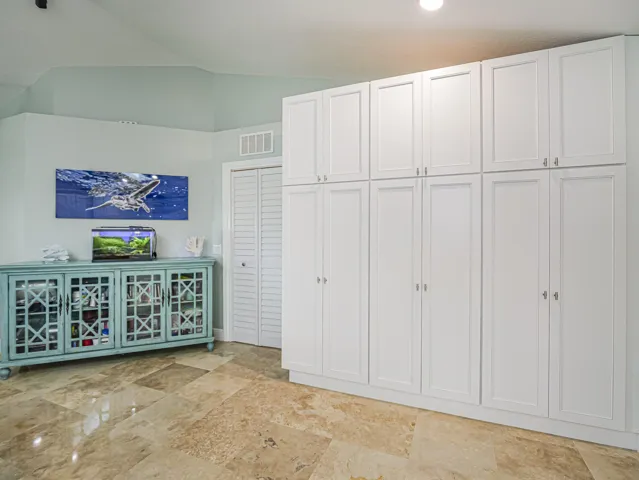 Expansive white cabinetry provides significant storage