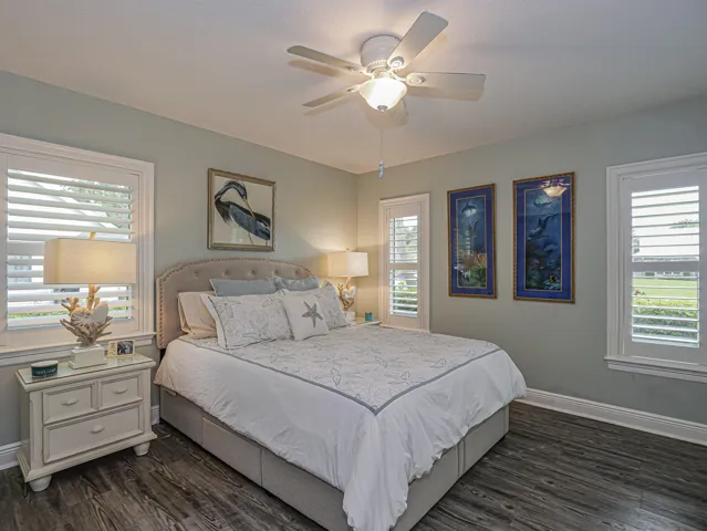Second bedroom, enjoys privacy and light. Plantation shutters and wood like vinyl floors.