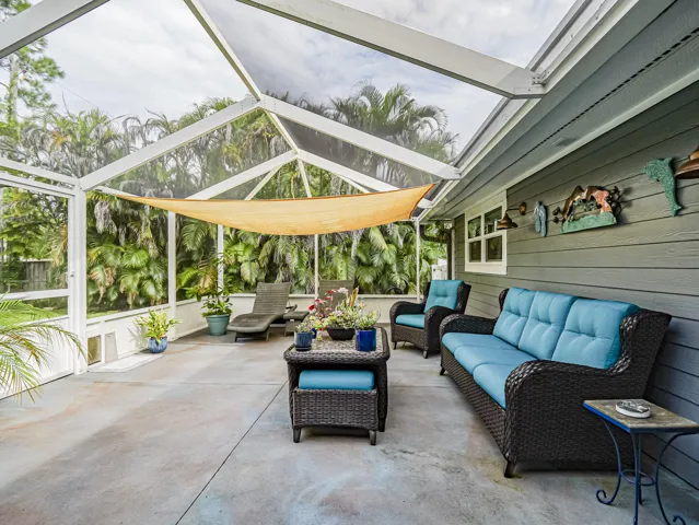 Screened outdoor area with textured concrete flooring.