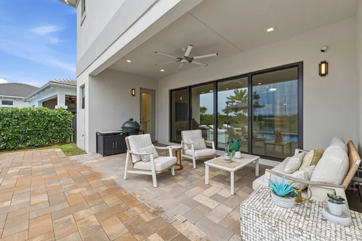 Covered patio featuring a ceiling fan, recessed lighting, and large format sliding glass doors