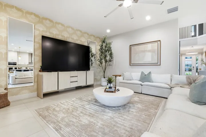 Recessed ceiling lighting, a modern ceiling fan, tall ceilings, and light-toned tile flooring