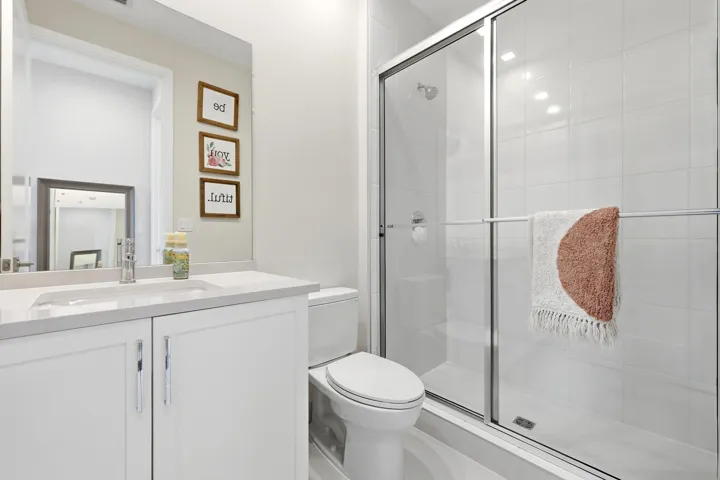 White vanity with an integrated sink, polished chrome faucet, and spacious countertop