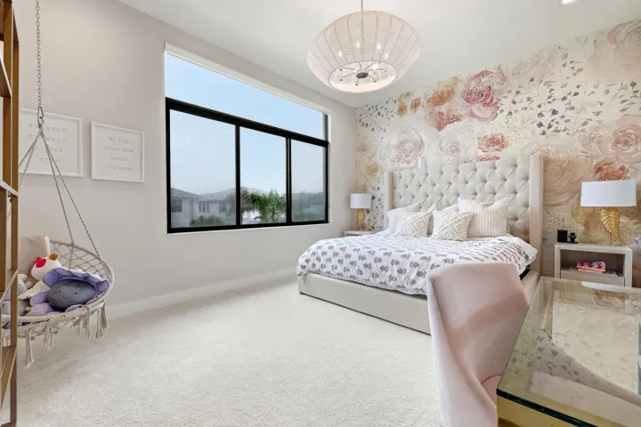 Full-height window with black framing, tufted headboard, floral accent wall, and built-in lighting fixture
