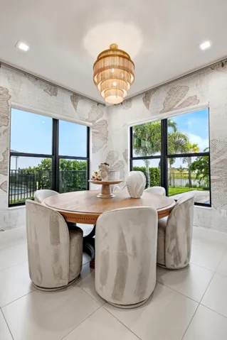 Bay windows with black frames, a tiered light fixture, and tile flooring