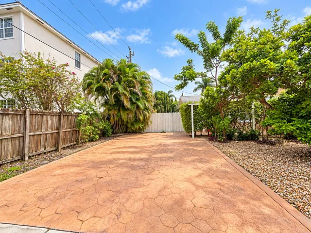 Sunlit Stamped Concrete Garden Driveway
