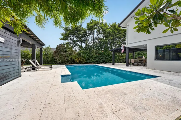 spacious back yard with a heated pool