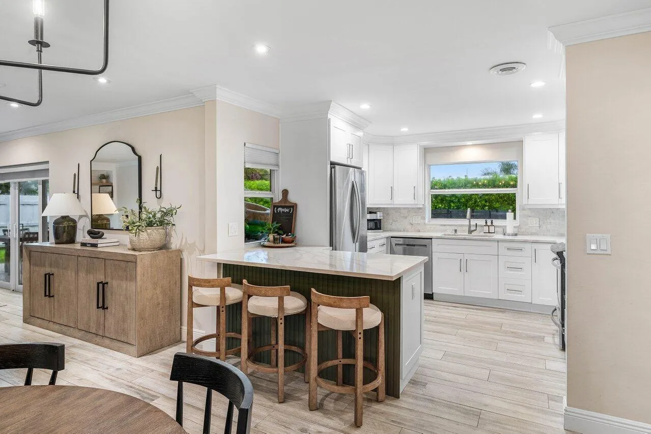 White cabinetry and breakfast bar seating.