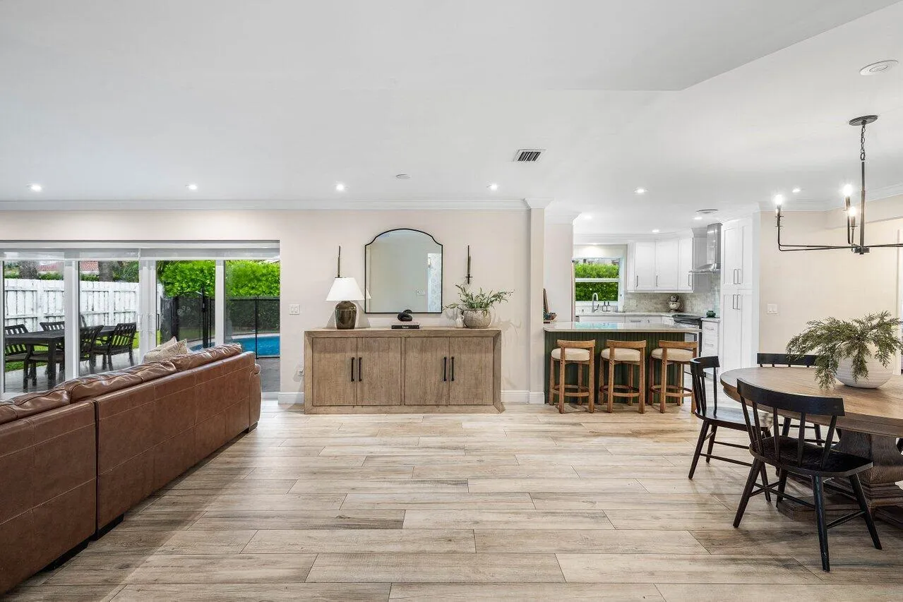 An open layout connects the living room, dining area, and kitchen.