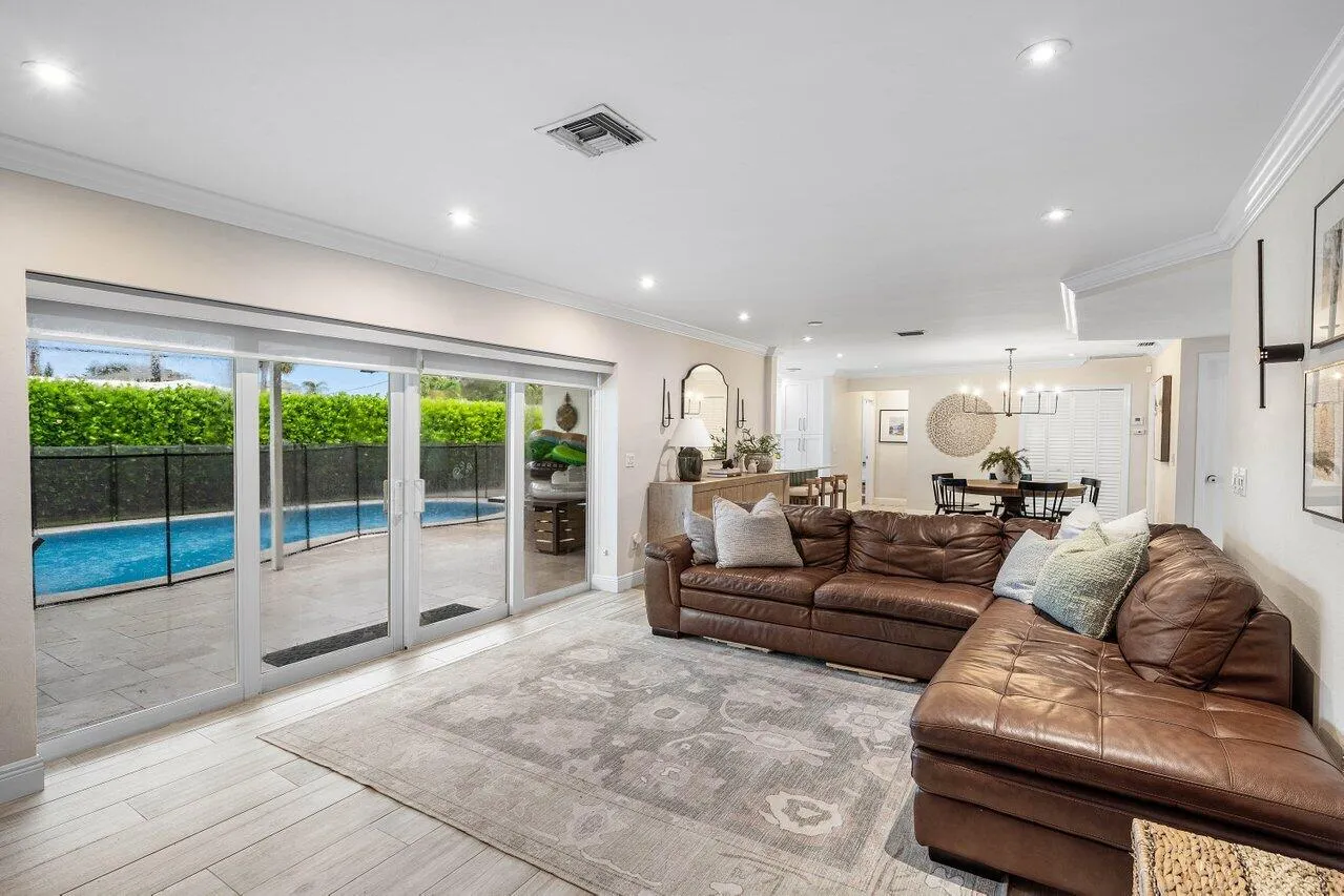 Sliding glass doors overlook the pool.