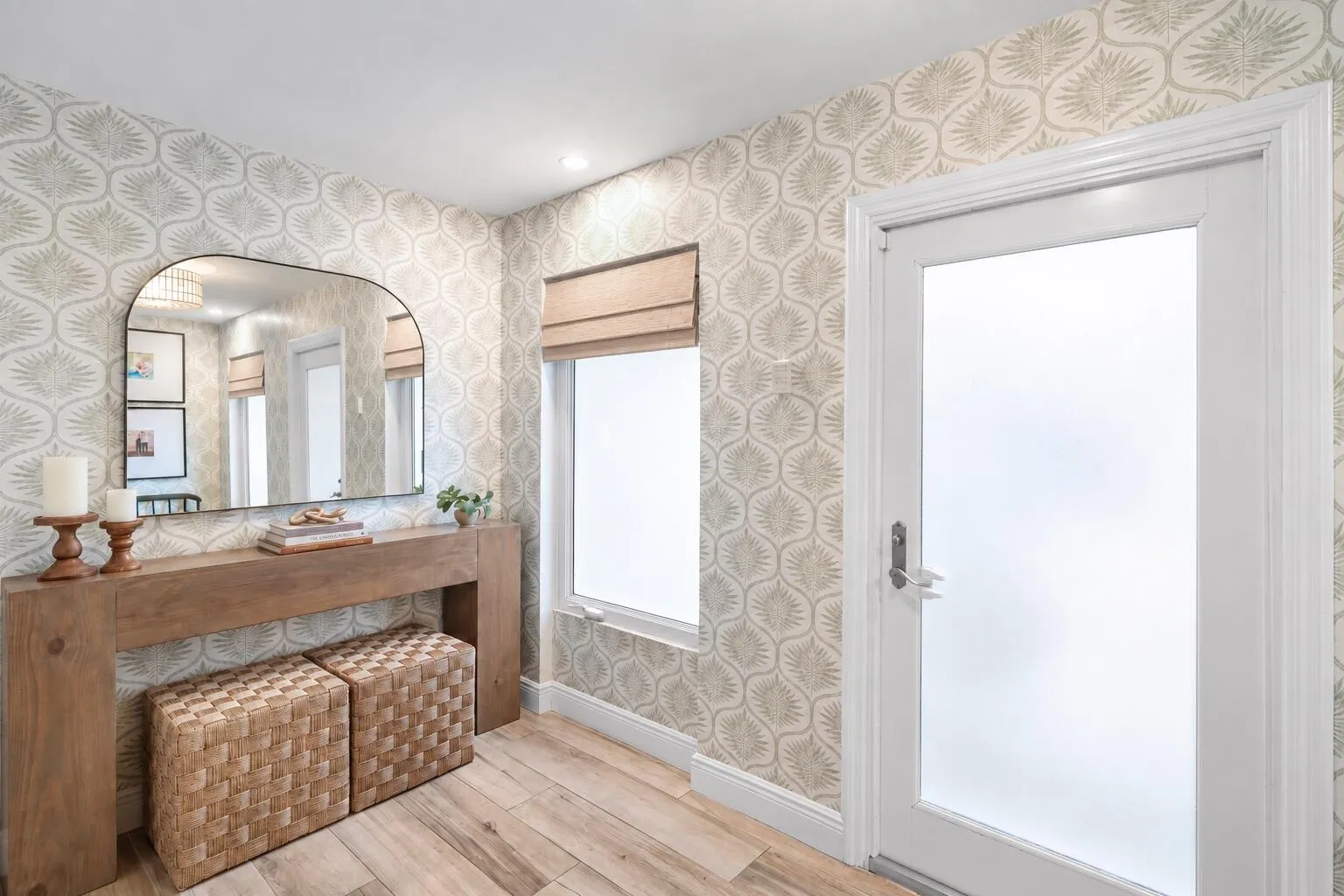 Patterned wallpaper and impact glass-paneled front door.