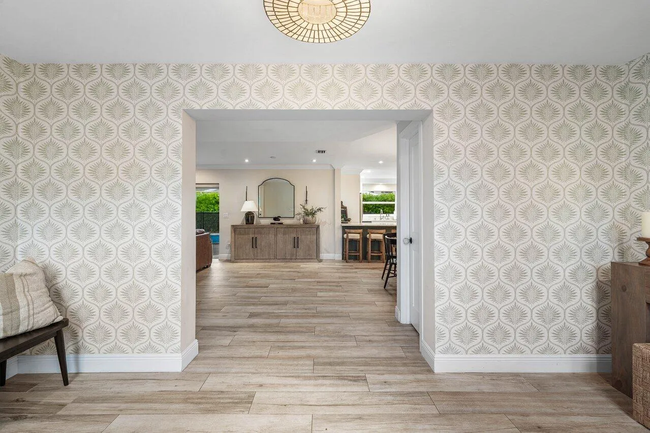 A wide opening connects the foyer to the home’s open living space.