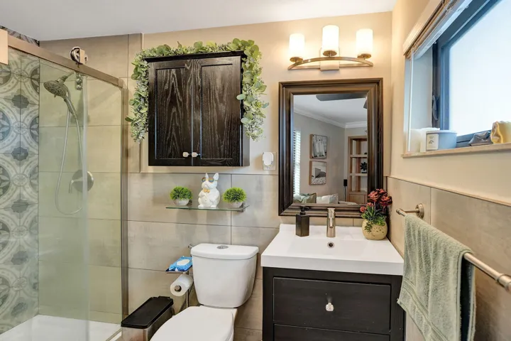 Bathroom with standing shower and frosted window for plenty of natural light