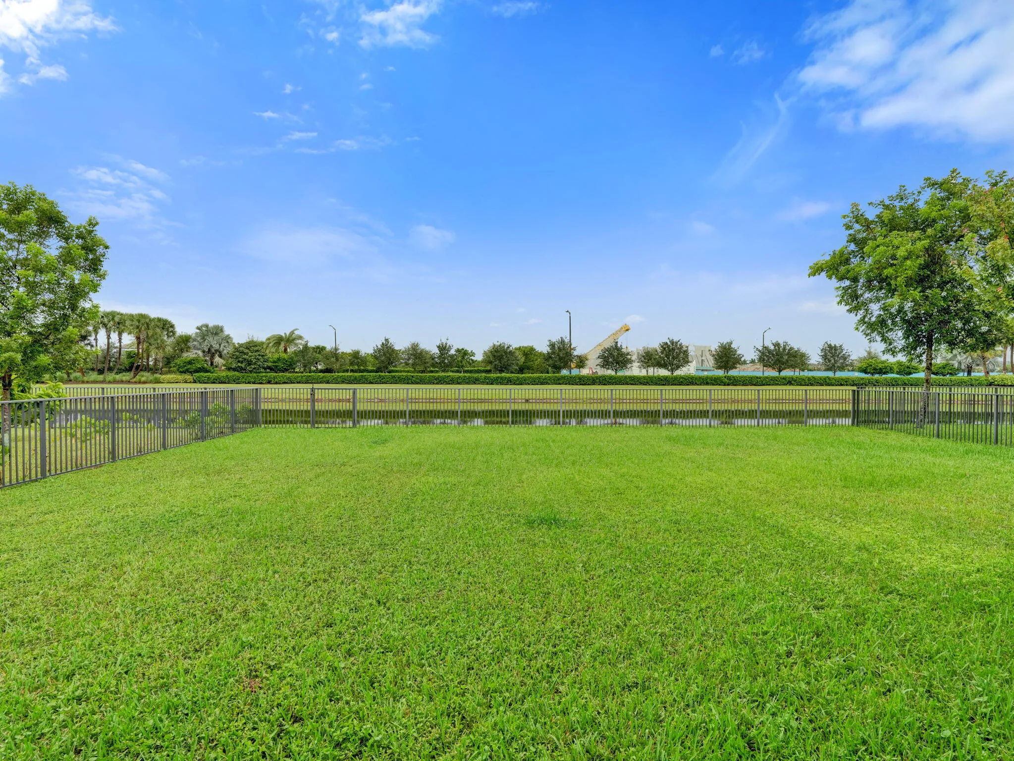 Expansive grassy yard with fencing