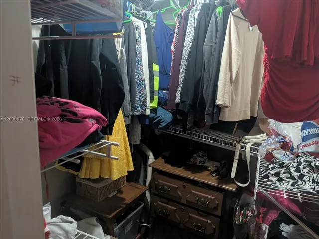 Closet featuring multi-level wire shelving and hanging rods