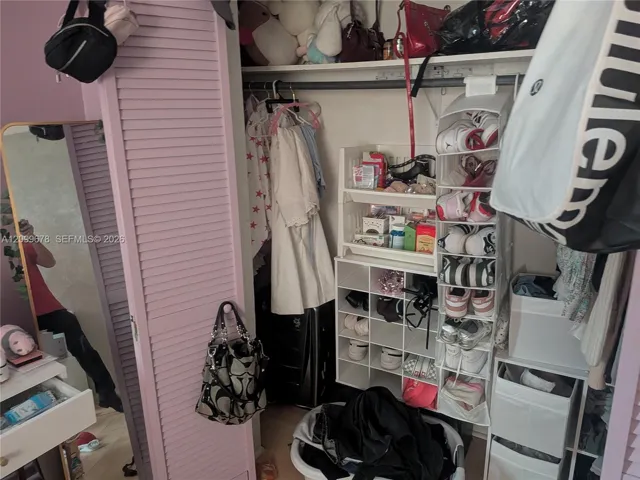 Closet featuring louvered bi-fold doors and a built-in horizontal clothing rod