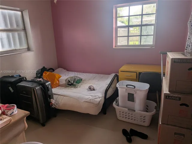 Room featuring two grid-paneled windows and neutral flooring