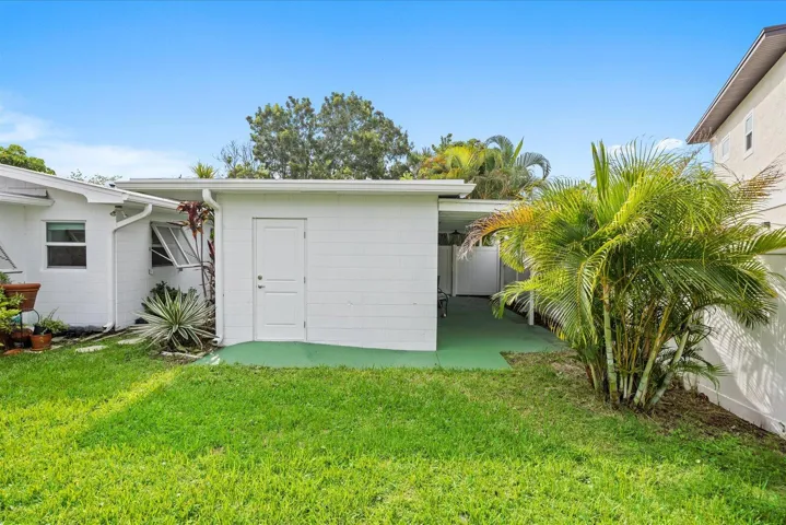 Grassy exterior area with mature tropical foliage
