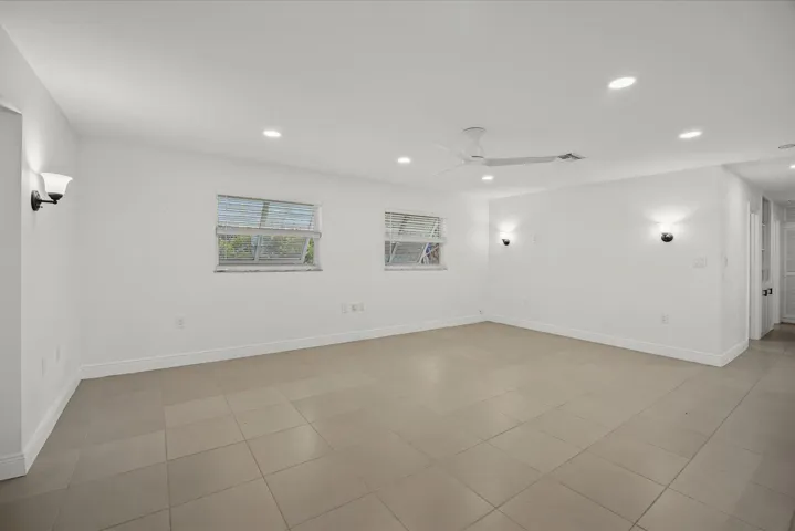 Recessed lighting, ceiling fan, sconce lighting, tiled flooring, and multiple windows