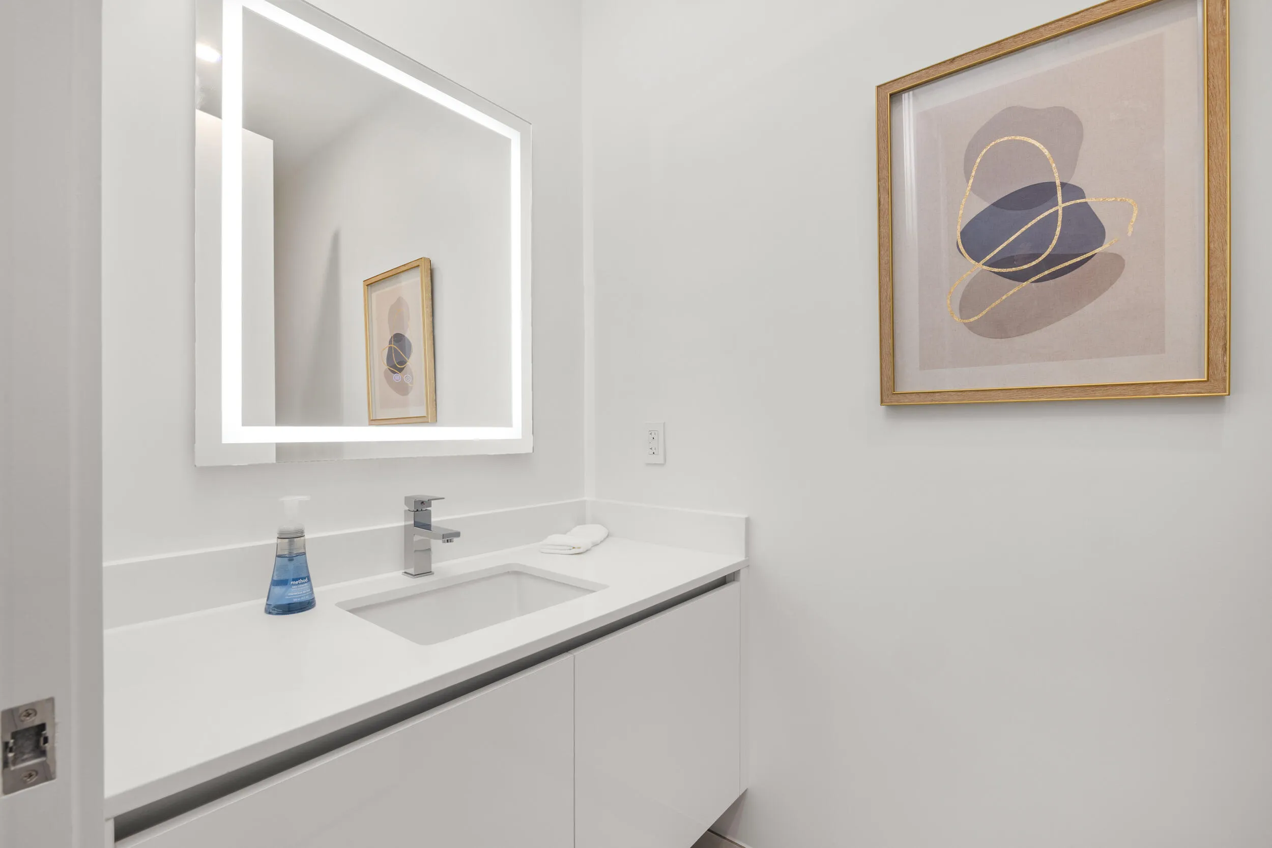 Half Bath - Integrated vanity with a rectangular undermount sink, chrome faucet, and white countertop
