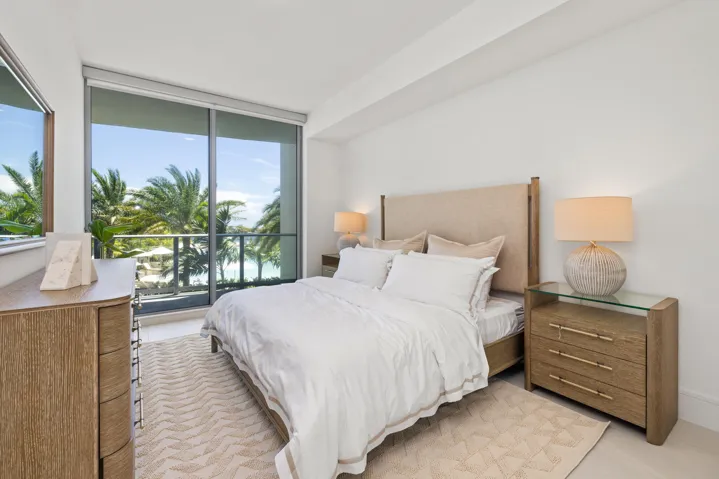 Floor-to-ceiling sliding glass doors, white walls, and a recessed ceiling