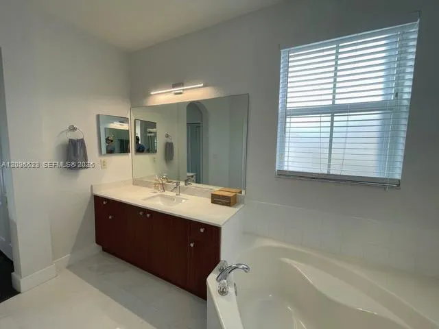 Upstairs shared bathroom with dual sinks, serving both bedrooms