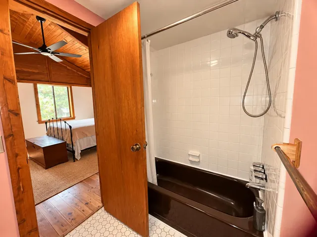 Rustic Bedroom Beyond Warm Tiled Bathroo