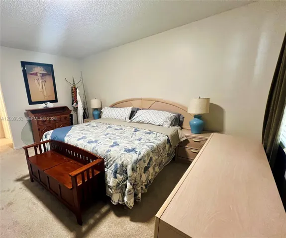 Neutral-toned interior space featuring light-colored wall-to-wall carpeting and smooth, finished wall surfaces