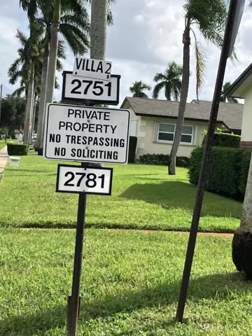 Sign showing entrance to villa 2 where the condo is located