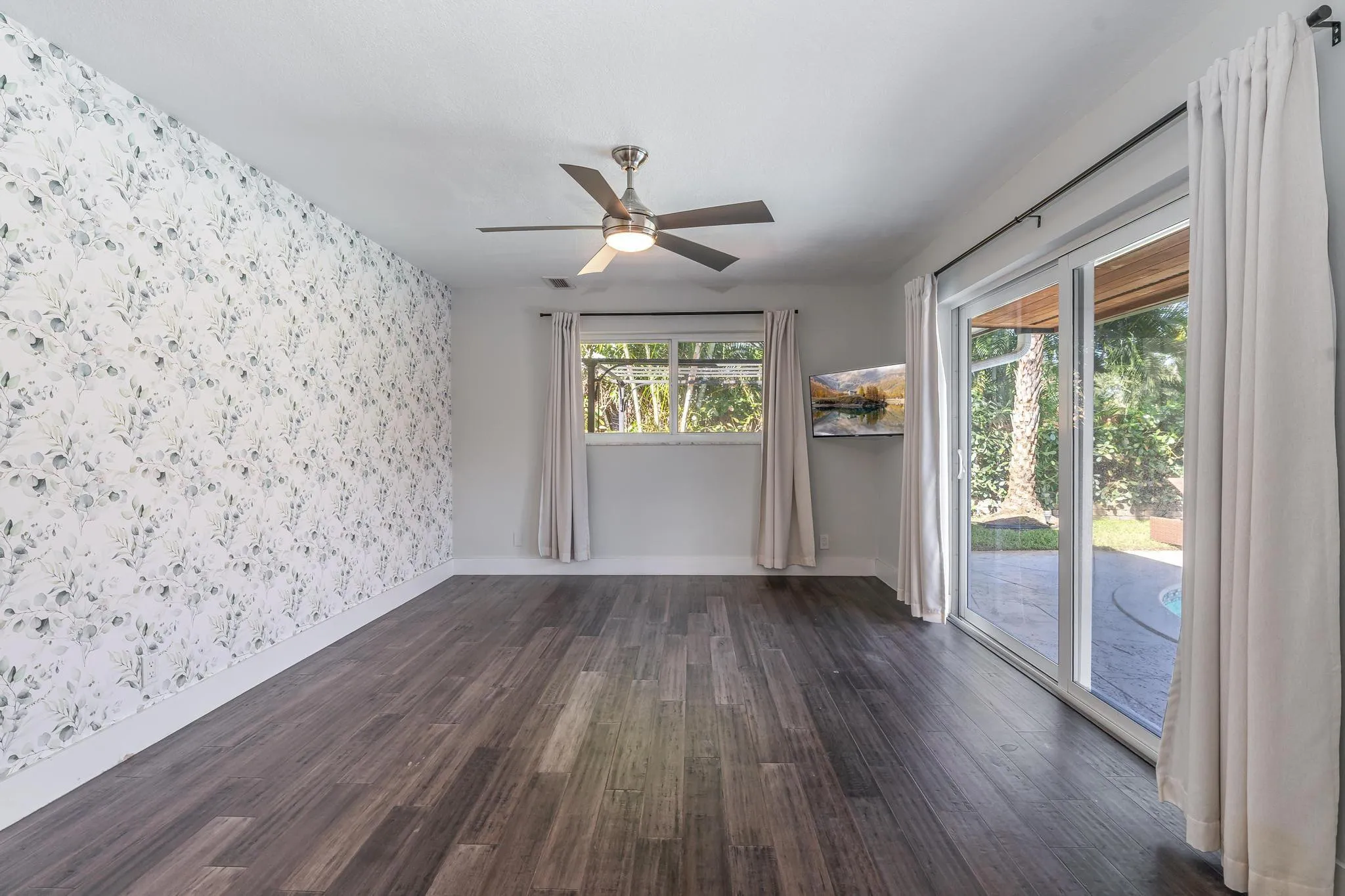 Primary bedroom with sliding glass doors