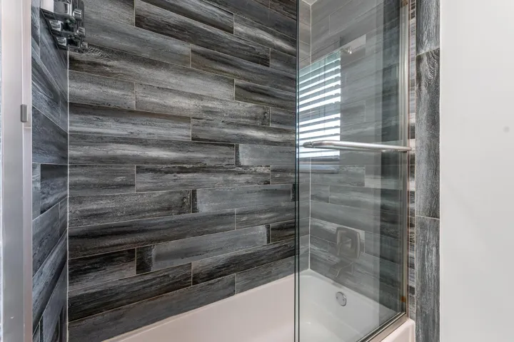Tiled tub and shower with glass door