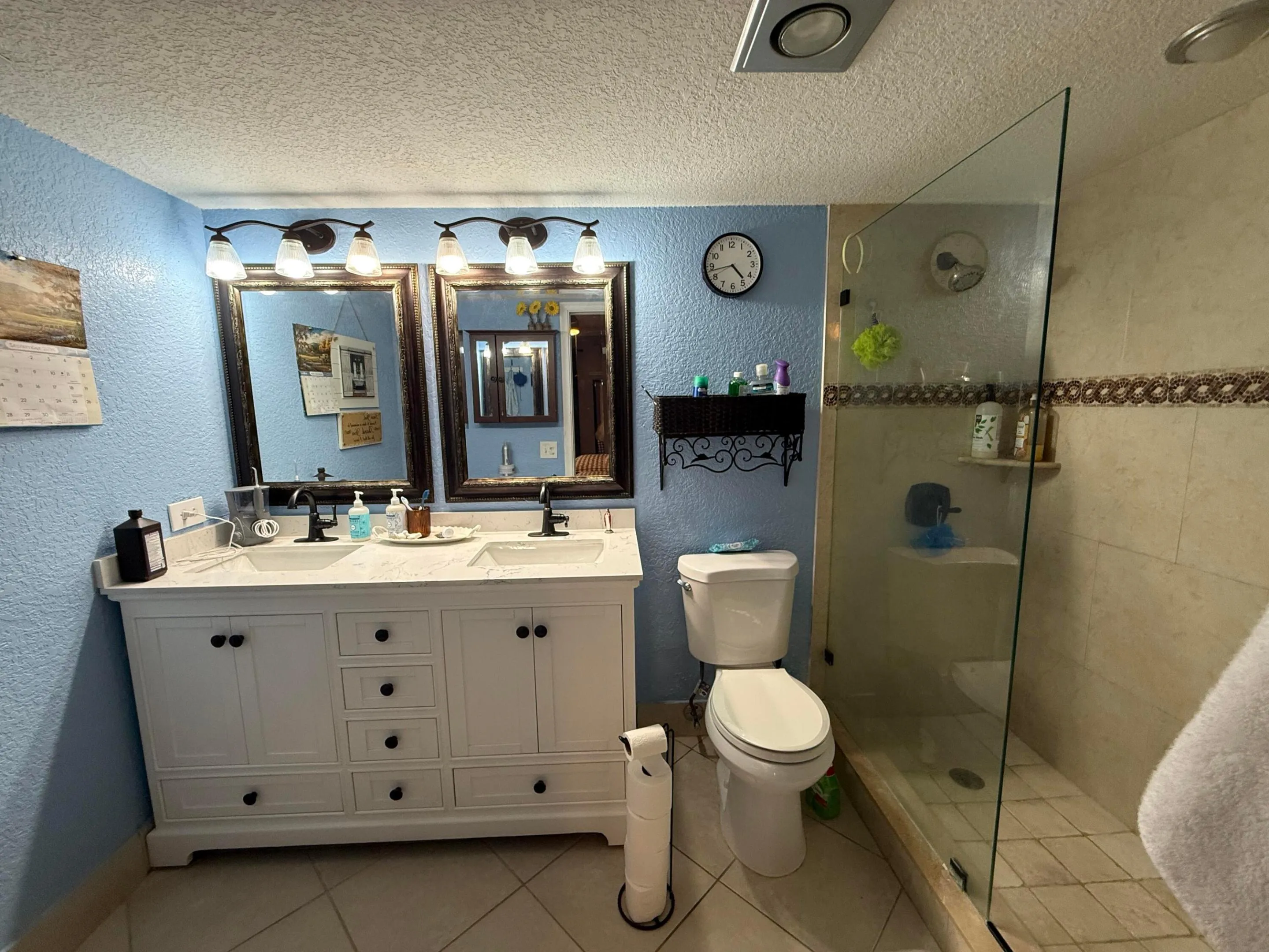Dual vanity with white cabinetry, countertop, and undermount sinks