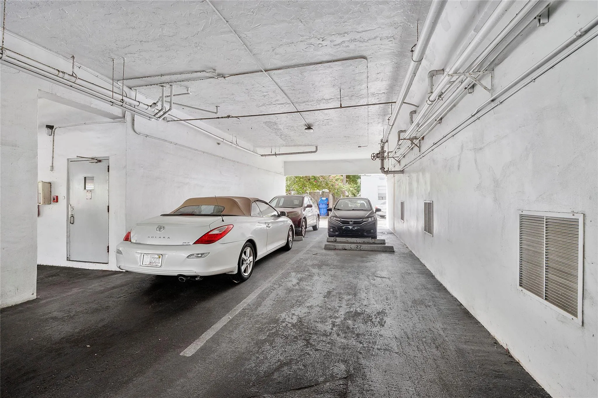 Actual parking space # 26. The space is to the left of the empty space with convertible parked in it.