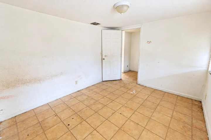 Empty Tile Room with Open Door