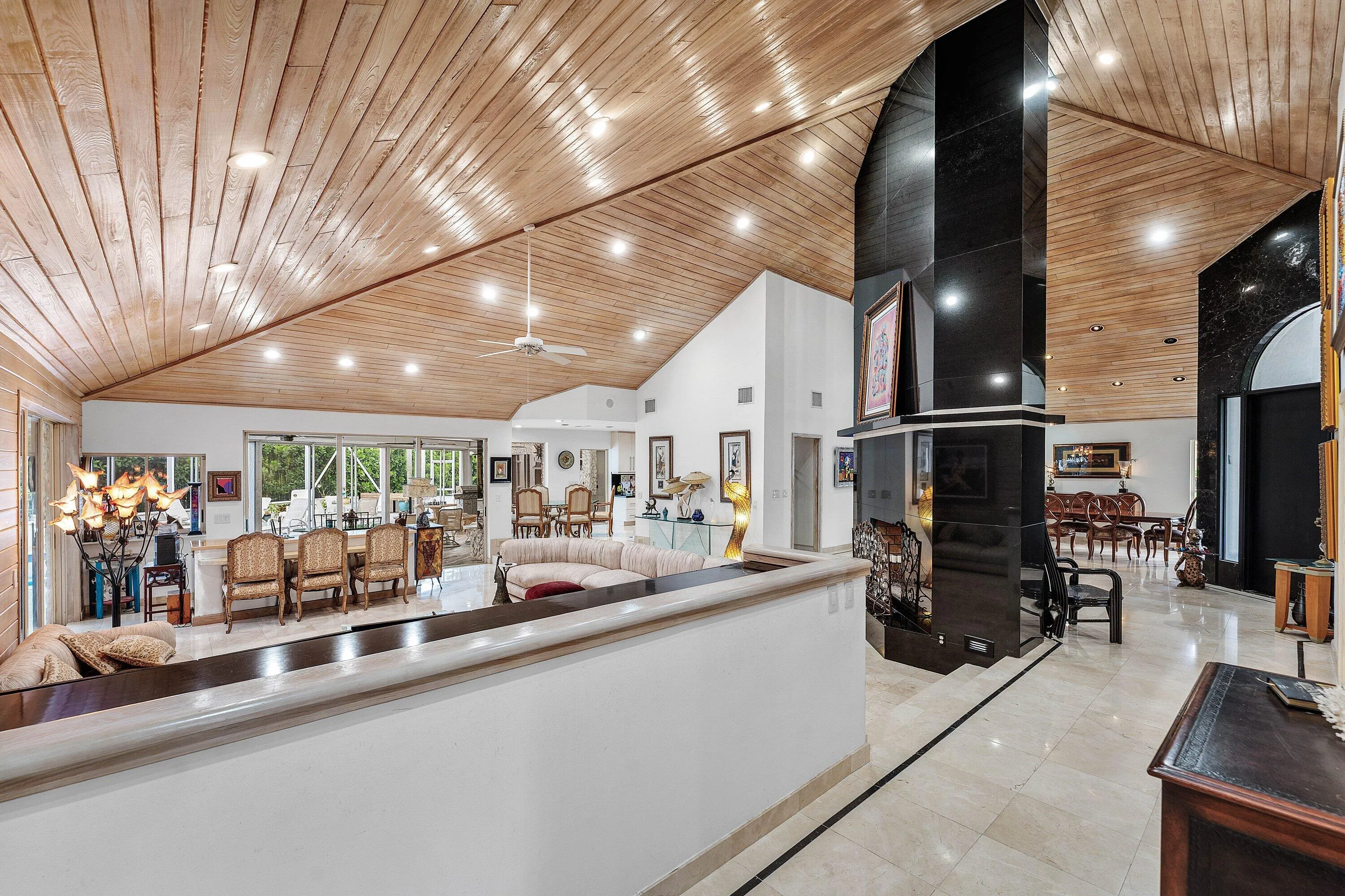 Expansive interior with vaulted wood-finish ceilings, recessed lighting, and tile flooring