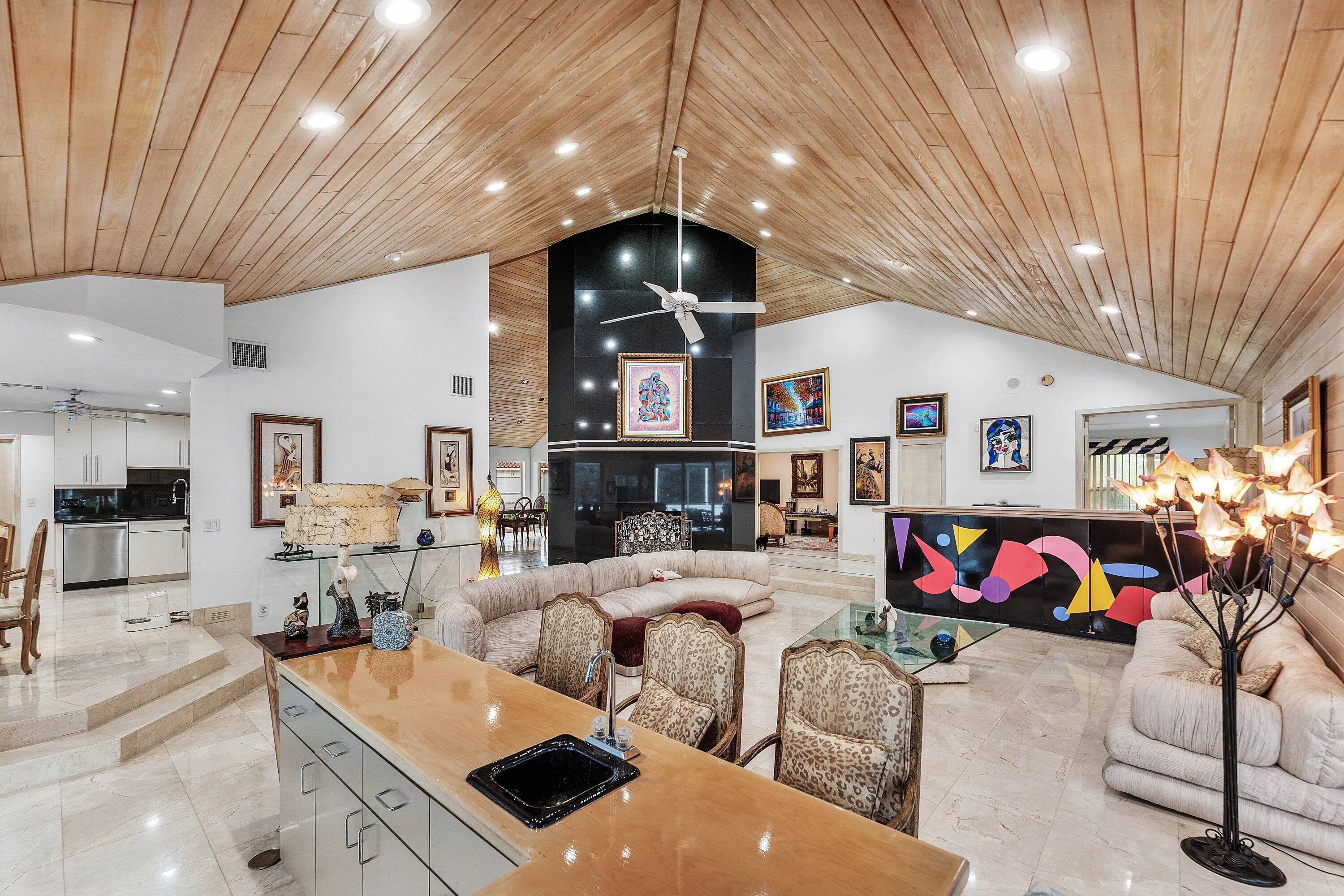 Vaulted wood-paneled ceiling with recessed lighting