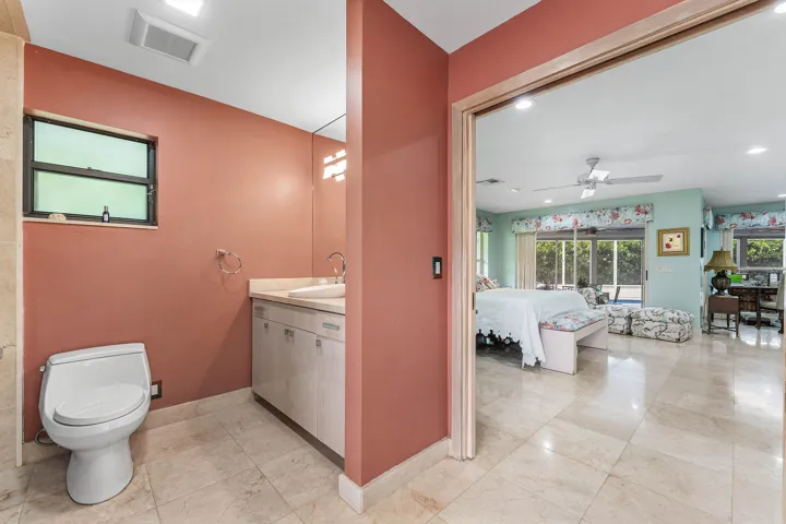 Bathroom with a vanity, integrated sink, and an expansive mirror
