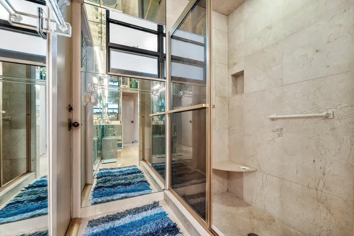 Shower enclosure with a built-in corner bench and recessed storage niche