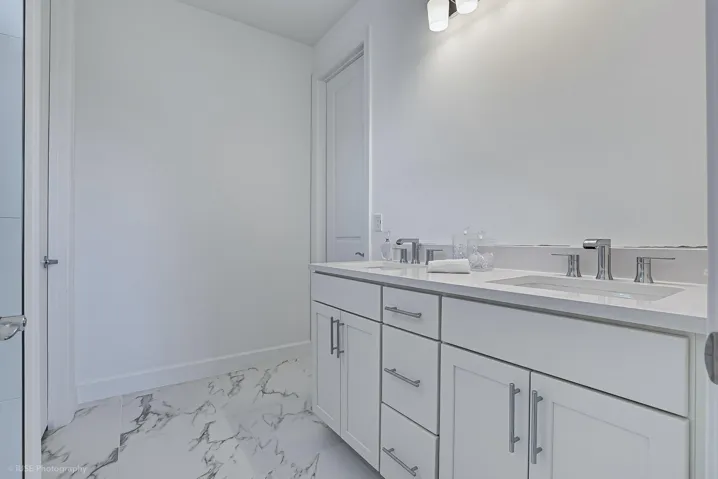 Double vanity in primary bath with quartz tops