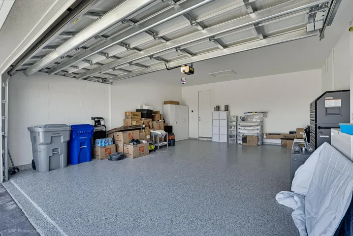 Garage with 4' extension, apoxy floors and hurricane rated garage door. This space will easily house a large SUV.