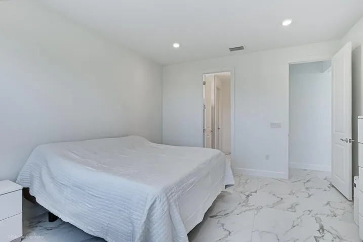 Large primary bedroom with plenty of natural light